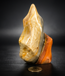 A side profile shot of the second crystal flame variant, emphasizing its bold orange and tan color blocking on a highly reflective polished surface.