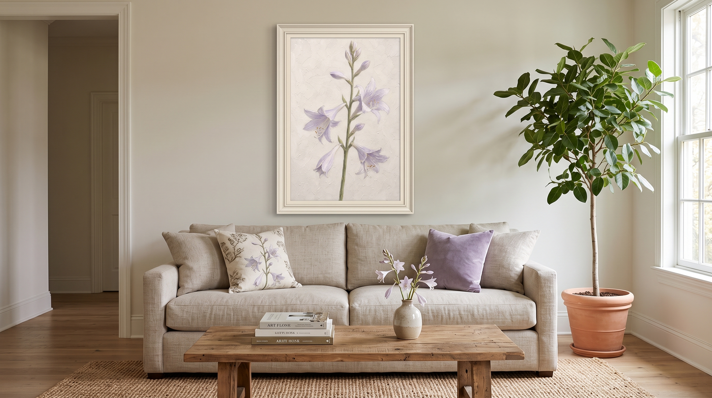 A cozy, neutral-toned living room featuring a small framed botanical illustration of purple lilies hanging on a beige wall, a rustic wooden coffee table, and a potted tree by the window.