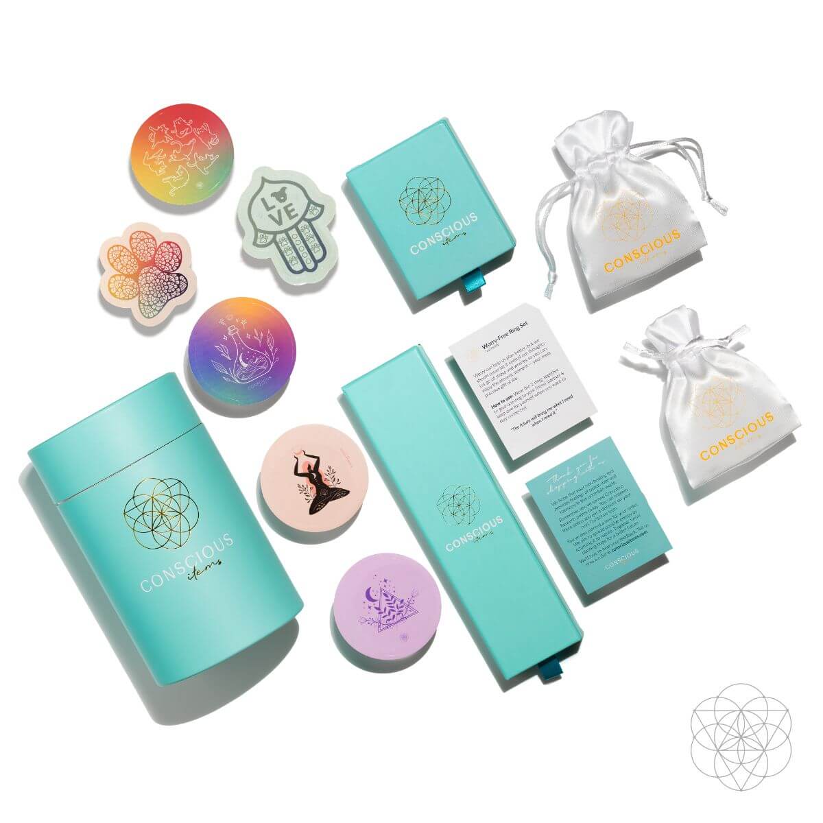 A full flat lay unboxing spread of the car crystal kit, showing the teal cylindrical packaging, white drawstring pouches, instruction cards, and colorful crystal accessories on a white surface.