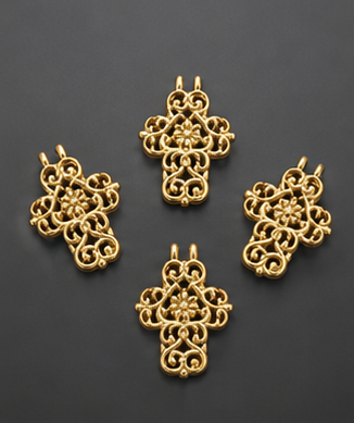 A set of four vibrant 22kt gold-plated openwork cross jewelry charms with twin attachment loops arranged symmetrically on a black background.
