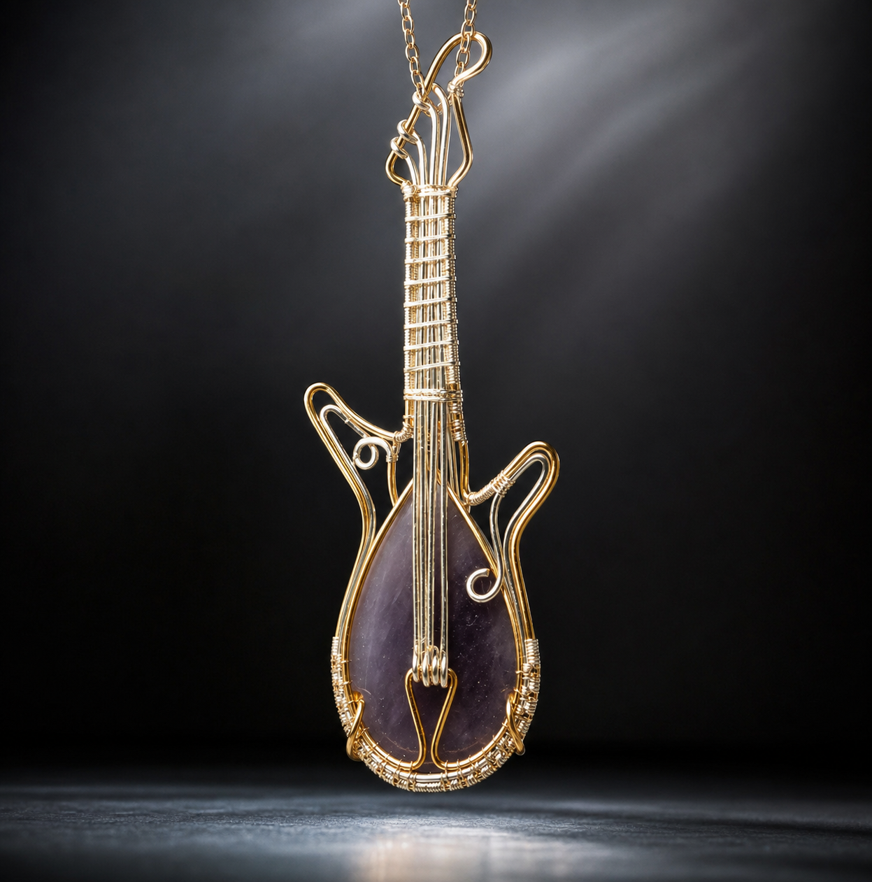 A detailed handcrafted wire-wrapped electric guitar pendant featuring a teardrop-shaped purple-grey agate gemstone body and woven metal strings, resting vertically on raw quartz crystals.