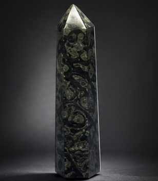 Front view of a slender 6-inch tall Kambaba Jasper crystal pillar featuring rich dark green and black fossil patterns.
