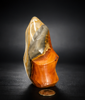 Front view of a second variant option of the Polychrome Jasper crystal flame, showcasing a vibrant, solid orange base beneath a cream and grey peak.