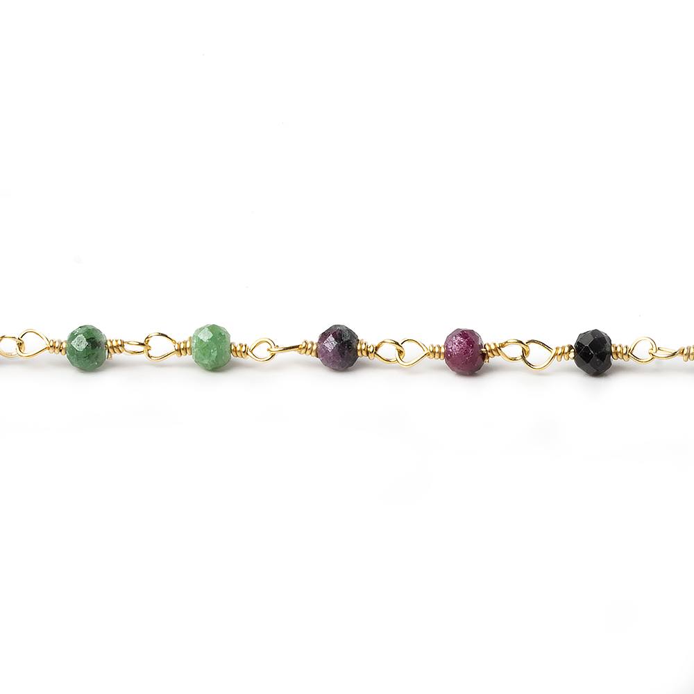 A straight horizontal view of a single strand of gold-plated rosary chain highlighting individual ruby in zoisite faceted gemstone beads against a white background.