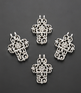 Four shimmering silver-plated lace filigree cross pendants showing the double top ring configuration against a dark studio background.